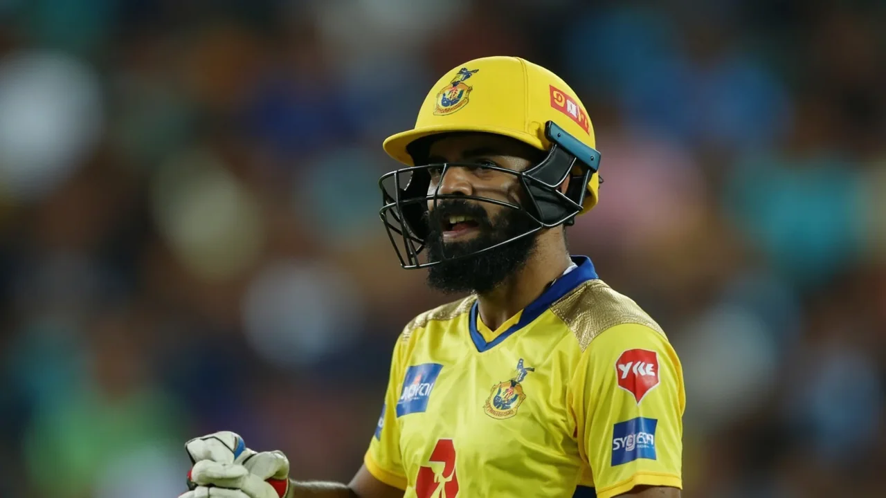 Cricket player preparing for a shot under match lights in a TNPL-style ground setting